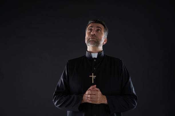 istock Priest looking up head eyes to heaven sky 1059535380
