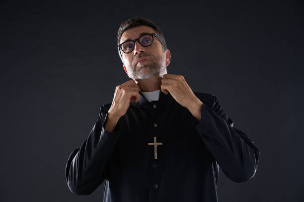 Priest dressing up fixing neck clergyman
