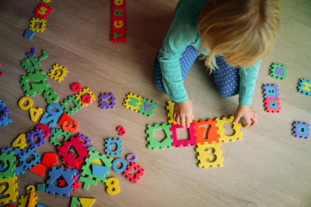 istock little girl learning numbers play with puzzle 1059537774