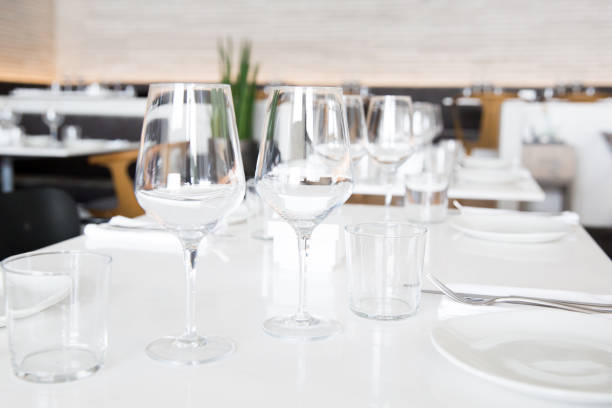 istock Beautifully decorated table with empty white plates, glasses and cutlery  on luxurious tablecloths 1059539986