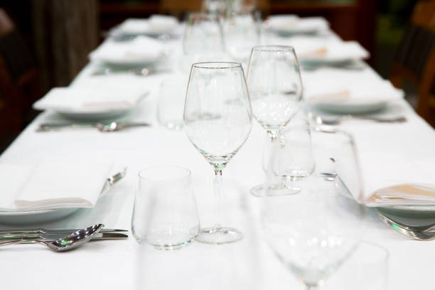 istock Beautifully decorated table with empty white plates, glasses and cutlery  on luxurious tablecloths 1059540520