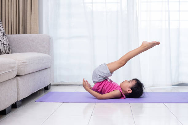 istock Asian Chinese little girl practicing yoga pose on a mat 1059541430