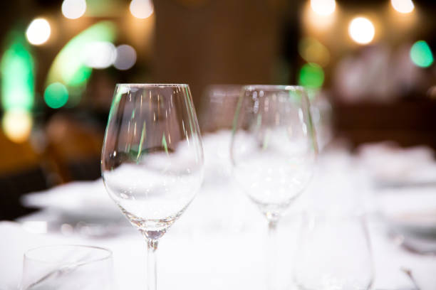 istock Beautifully decorated table with empty white plates, glasses and cutlery  on luxurious tablecloths 1059541958