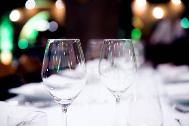 istock Beautifully decorated table with empty white plates, glasses and cutlery  on luxurious tablecloths 1059541998