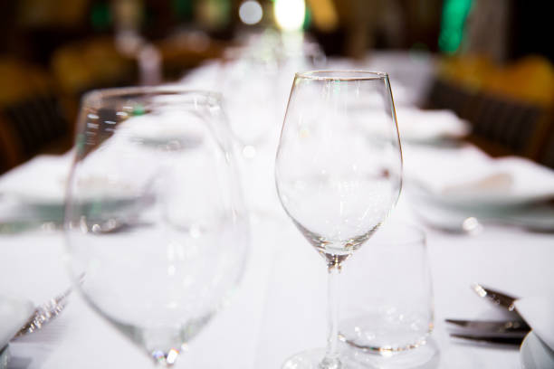 istock Beautifully decorated table with empty white plates, glasses and cutlery  on luxurious tablecloths 1059543332