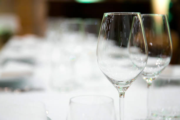 istock Beautifully decorated table with empty white plates, glasses and cutlery  on luxurious tablecloths 1059543612