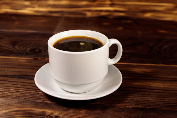 istock Cup of coffee on the wooden table 1059549172