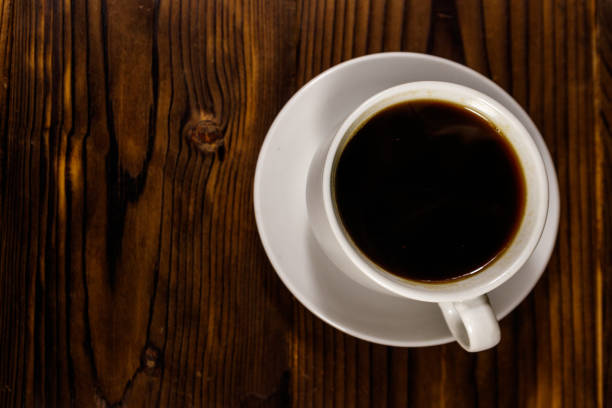 istock Cup of coffee on the wooden table. Top view 1059549188