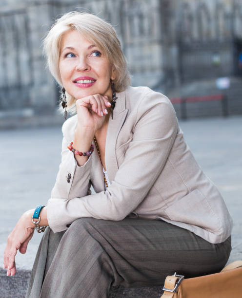 istock Cheerful mature female is walking sitting in classic jacket 1059552470