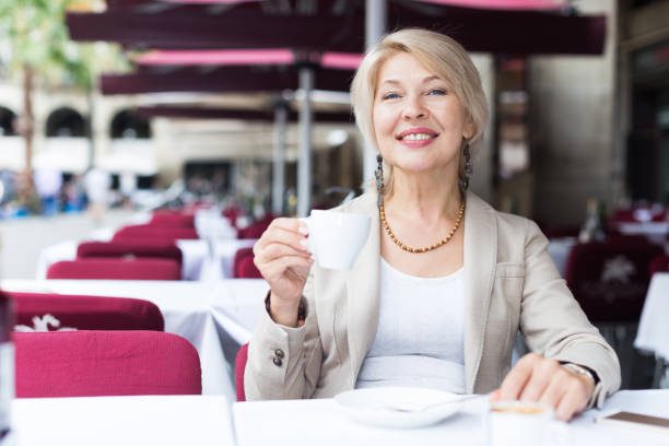 istock Mature businesswoman is drinking coffee 1059552560