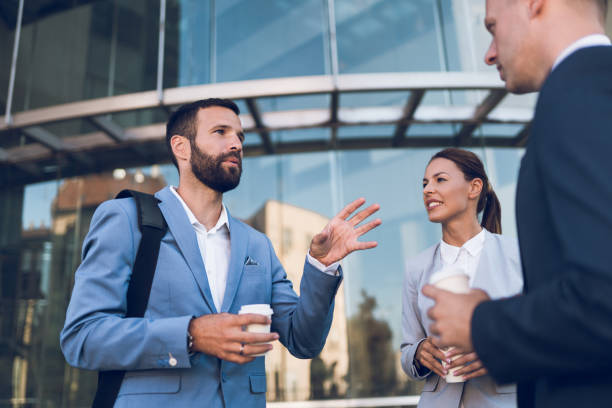 istock Three business colleagues having discussion while standing outdoors 1059552982