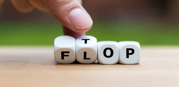 istock Hand is turning dice and changes the word Flop to Top 1059556112