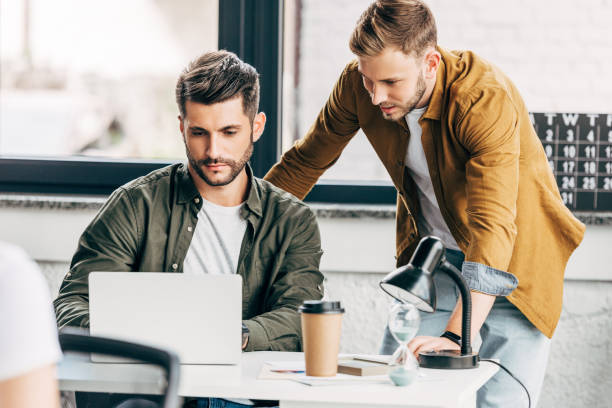 istock handsome young businessmen working with laptop together at office 1059568180