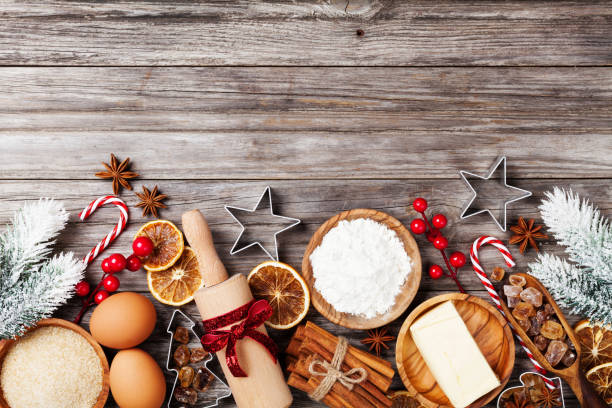 istock Bakery background with ingredients for cooking christmas baking decorated with fir tree. Flour, brown sugar, eggs and spices on kitchen table top view. 1059572932