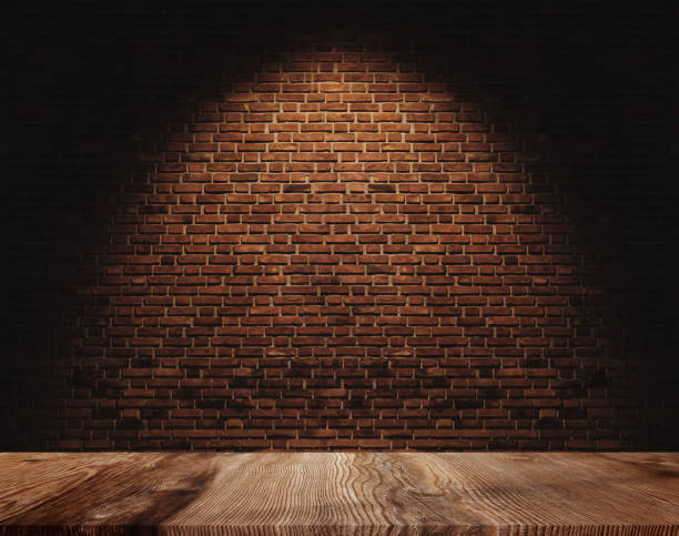 istock Brick wall and wooden floor, with light spot on centre for background 1059580144