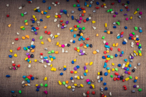 Colorful pebbles spread on a canvas background