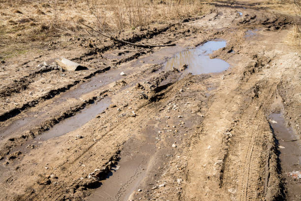 istock Deep car rut on a dirt road 1059595560
