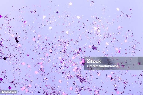 Violet Confetti And Violet Stars And Sparkles On Violet Background Stock Photo - Download Image Now