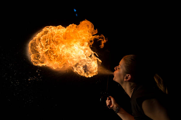 istock Fire breather blowing fire ball from her mouth 1059604110