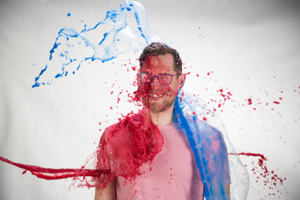 istock Watercolour paints splashing on young man 1059610156