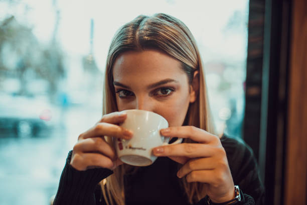 istock Stylish woman drinking coffee indoors 1059615624
