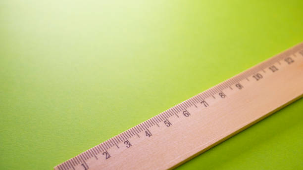 istock Wooden ruler on green background 1059615864