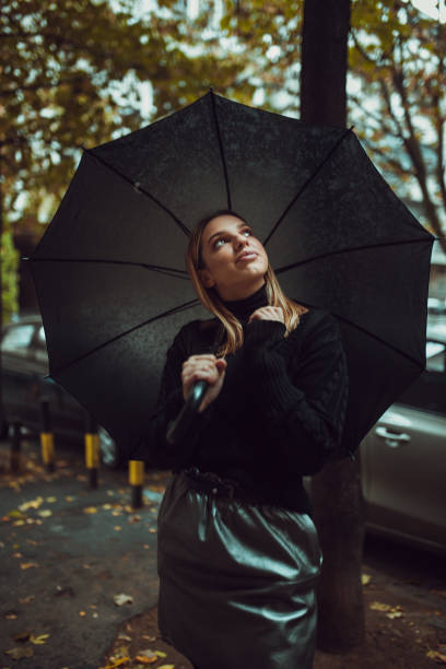 istock Stylish woman with umbrella 1059616040