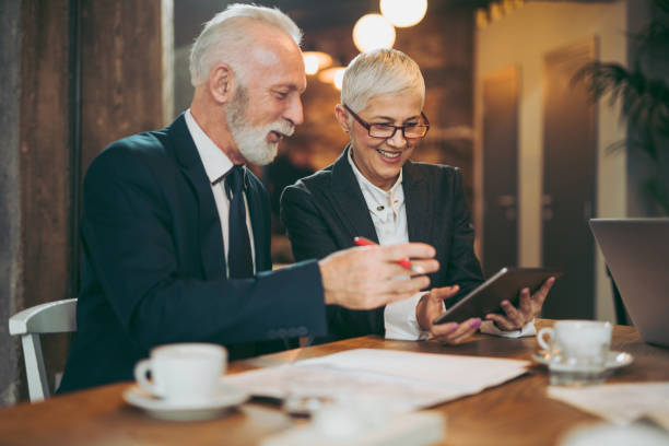 istock Senior business people using digital tablet in cafe 1059617366