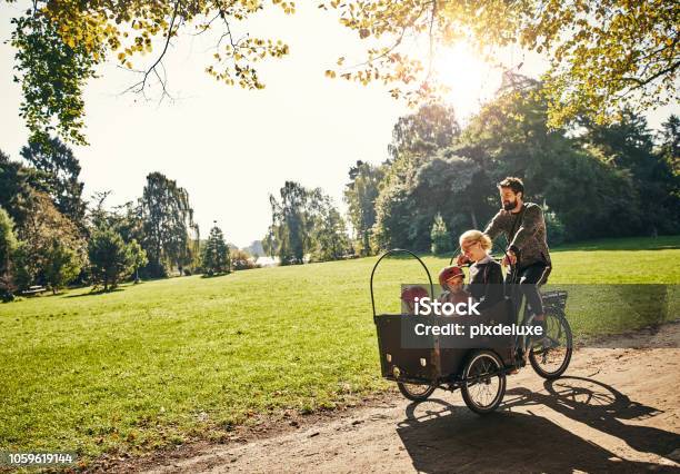 Cycling Through The Park Stock Photo - Download Image Now - Family, Cycling, Cargo Bike