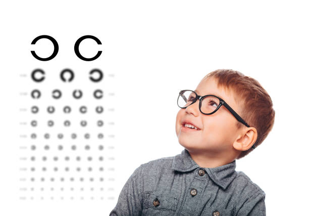 istock little boy taking eye exam with eye chart 1059622906