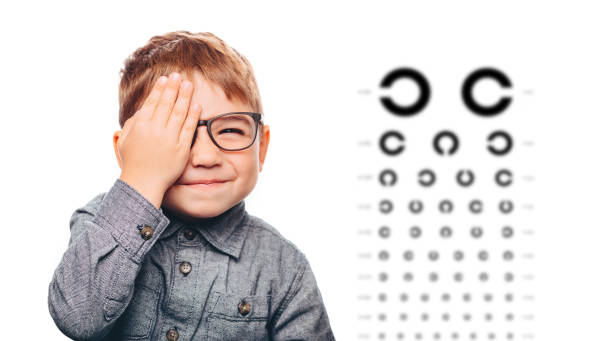 little boy having eye exam with eye chart