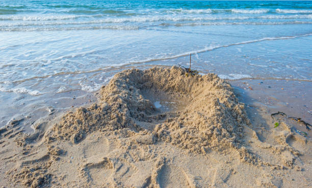 istock Beach along sea below a blue cloudy sky at fall 1059623738