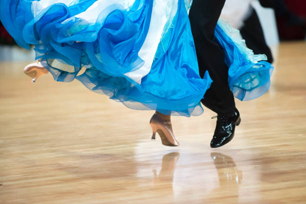istock Low Section Of Couple Dancing On Hardwood Floor 1059627022