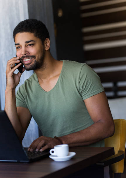 istock Young influencer and blogger having a phone call in a cafe 1059628136