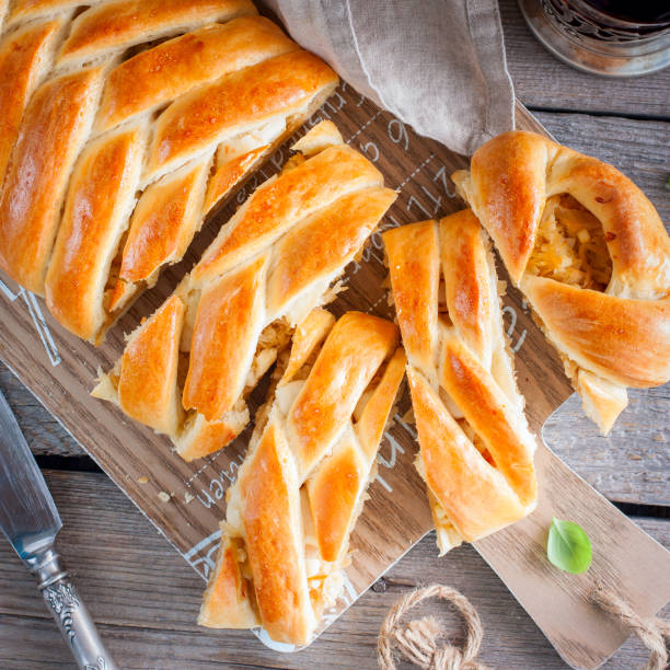 istock Kulebyaka, traditional for Russian cuisine pie from yeast dough with cabbage, top view, square 1059630184