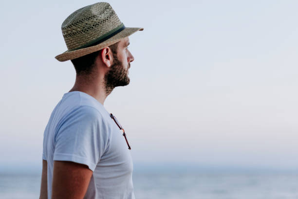 istock Man enjoying sunset by the sea 1059631942