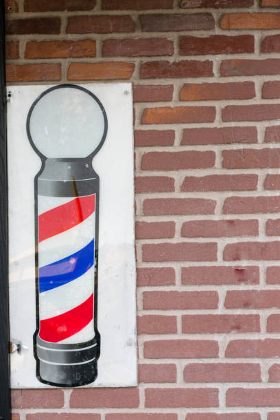 istock Barbershop symbol against a brick wall backdrop 1059632796