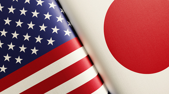 American and Japanese flag pair. Horizontal composition with copy space and selective focus.