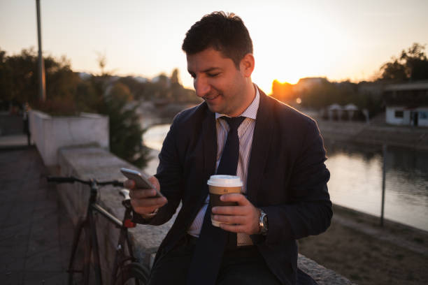 istock Businessman using smartphone after job 1059636098