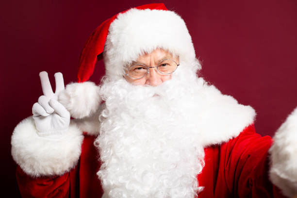istock Santa Clause showing peace sign and makes selfie photo 1059636246