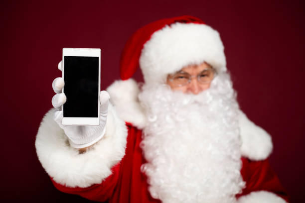 istock Santa shows blank screen of phone 1059636854