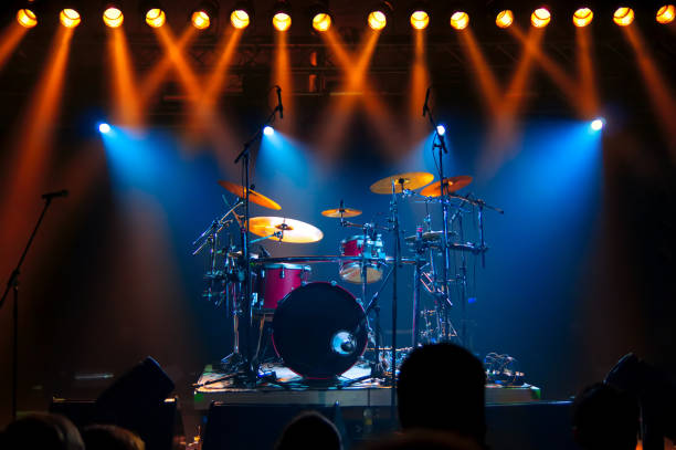 istock Illuminated Lights Falling On Drums At Stage During Music Concert 1059636856