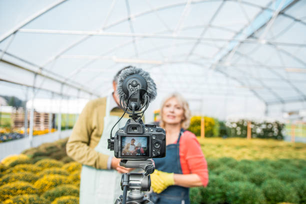 istock Senior people working in a greenhouse and vlogging about it 1059637058