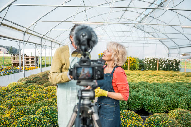 istock Senior people working in a greenhouse and vlogging about it 1059637064
