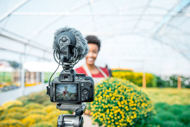 istock Young black woman vlogging in a greenhouse 1059637144