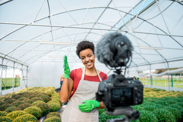 istock Young black woman vlogging in a greenhouse 1059637160