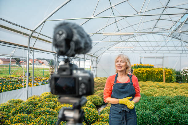istock Senior woman vlogging in a greenhouse 1059637164