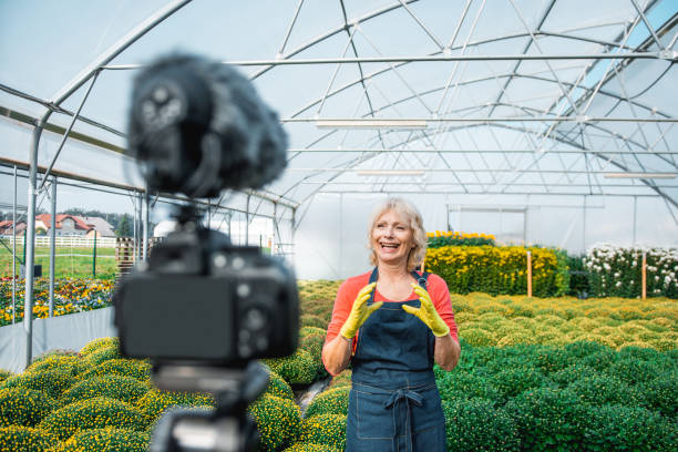 istock Senior woman vlogging in a greenhouse 1059637192