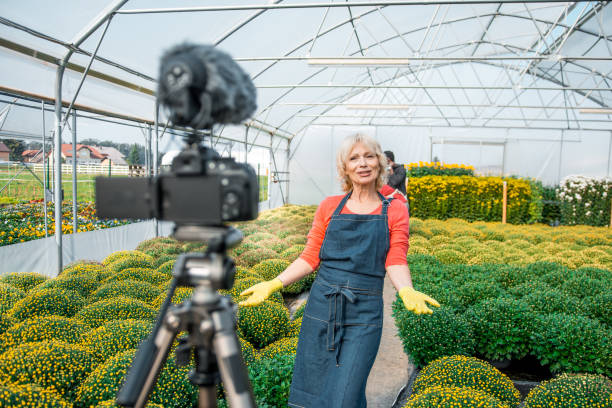 istock Senior woman vlogging in a greenhouse 1059637194