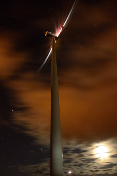 istock Wind turbine producing electricity during the night. 1059640320